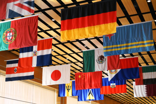 hanging flags of multi nations from school gym ceiling