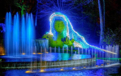 Green Woman lit up with lights located at the Atlanta Botanical Garden