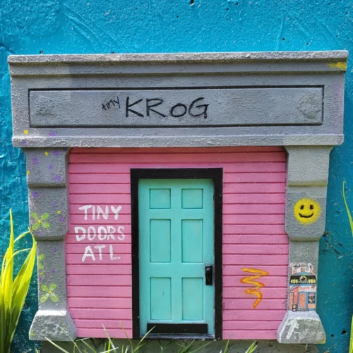 a miniature doorway on the side of a building.