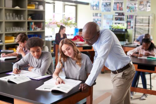 Biology High School Teacher helping student with class work