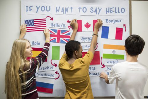 High School Students Working On International Flags Board