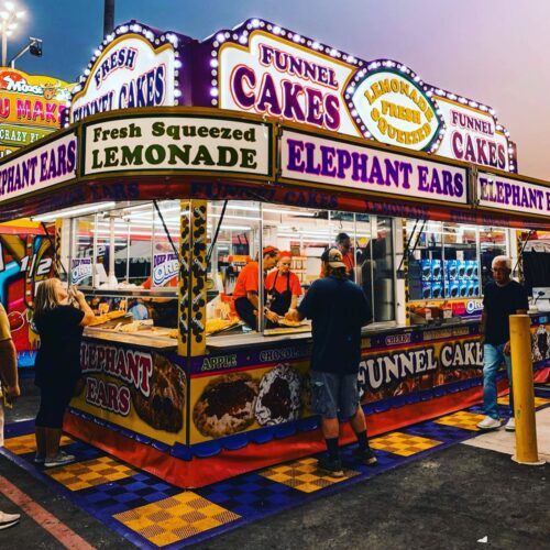 carnival funnel cake vendor at sunset